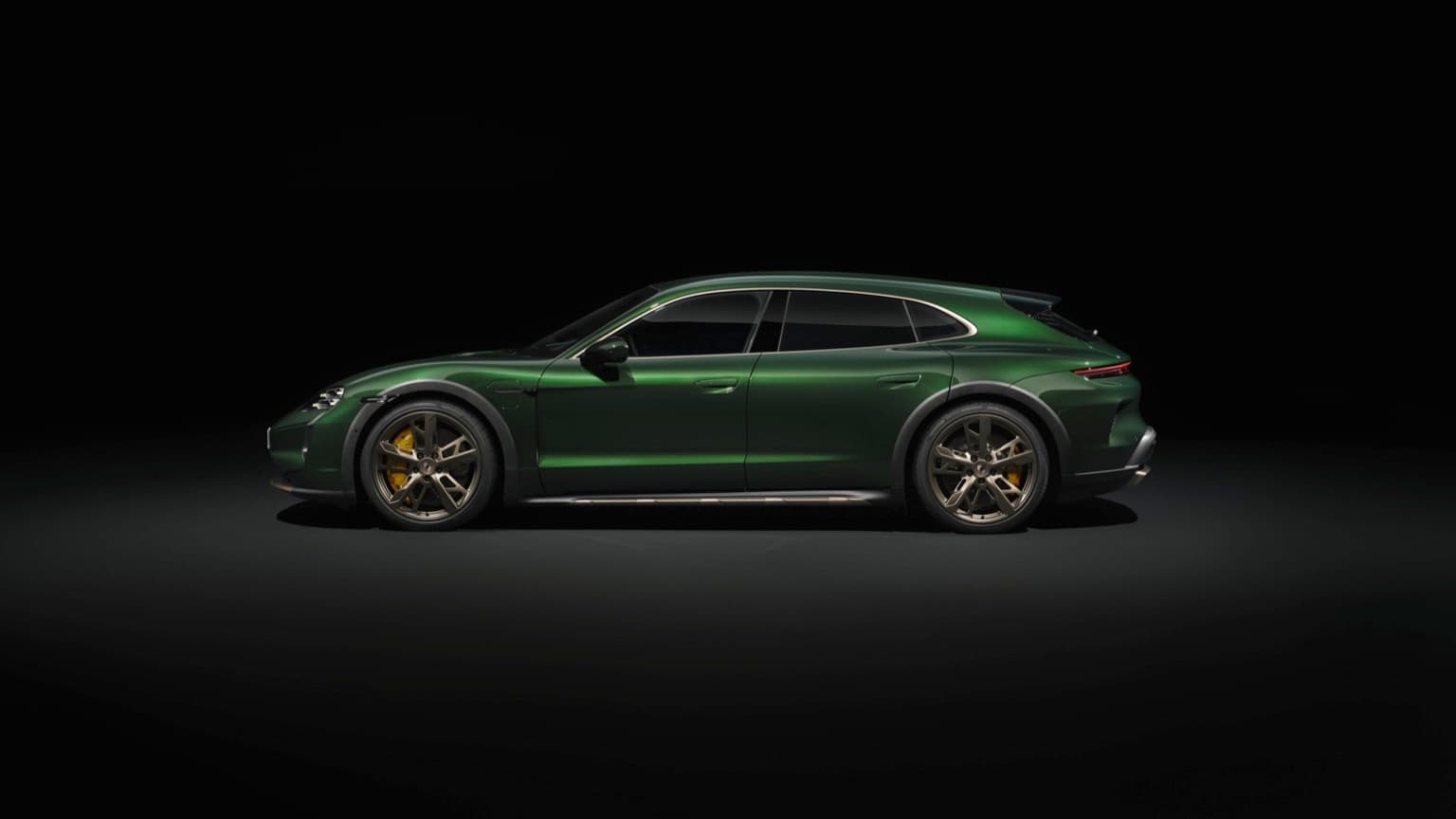 a green sports car in a dark room