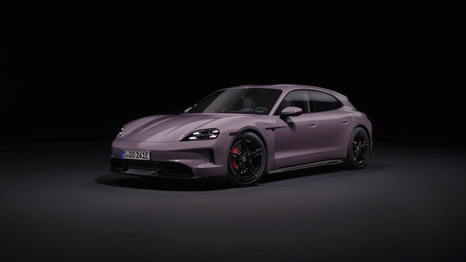 a purple sports car in a dark room