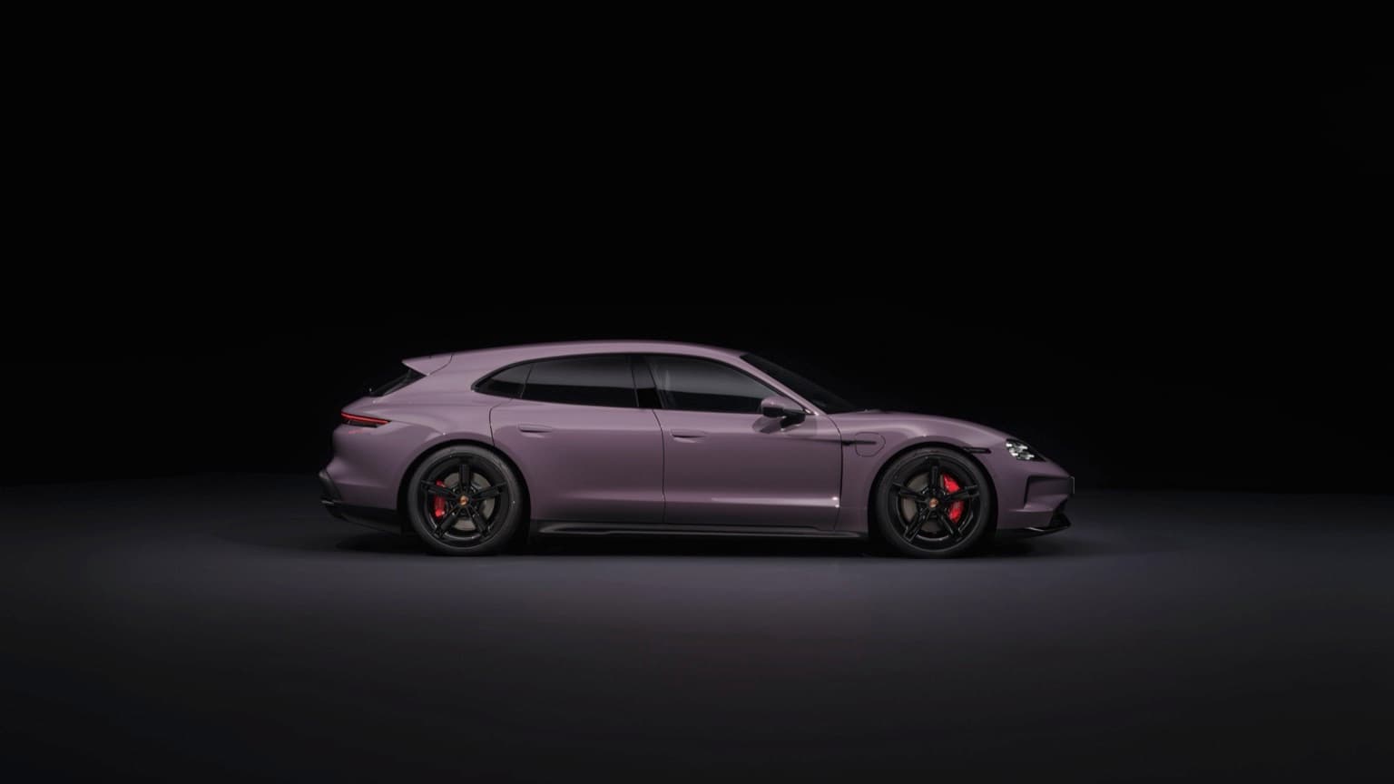 a purple sports car in a dark room