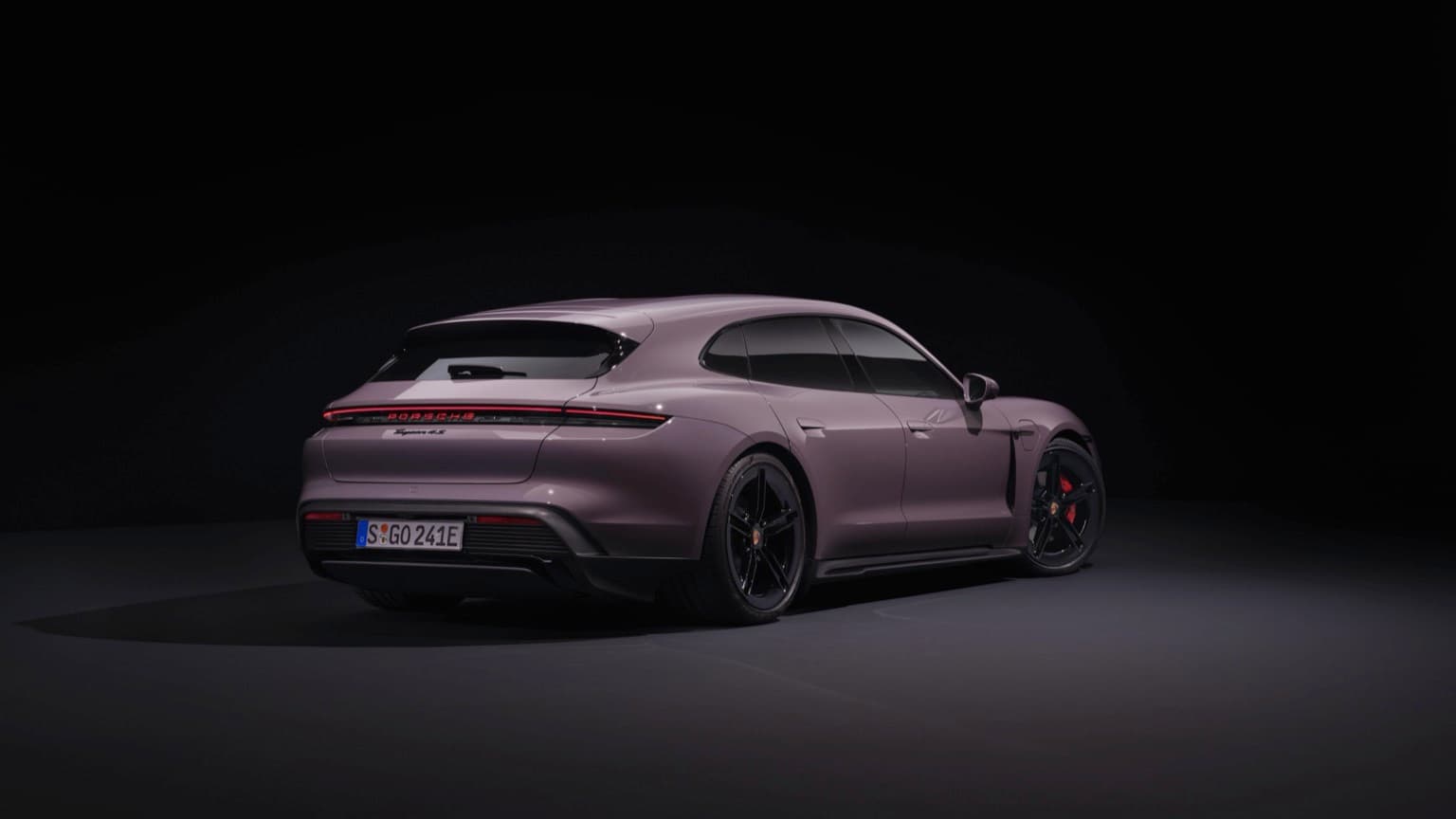 a purple sports car in a dark room