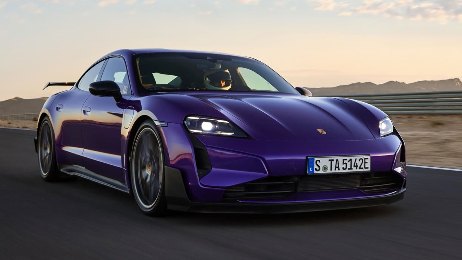 a purple sports car on a road