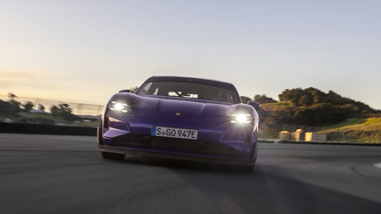 a purple sports car with headlights on