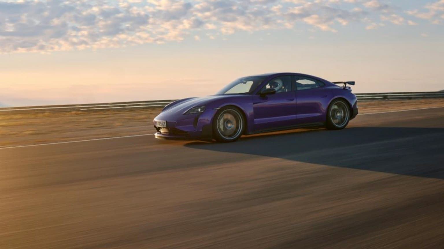 a purple sports car on a road