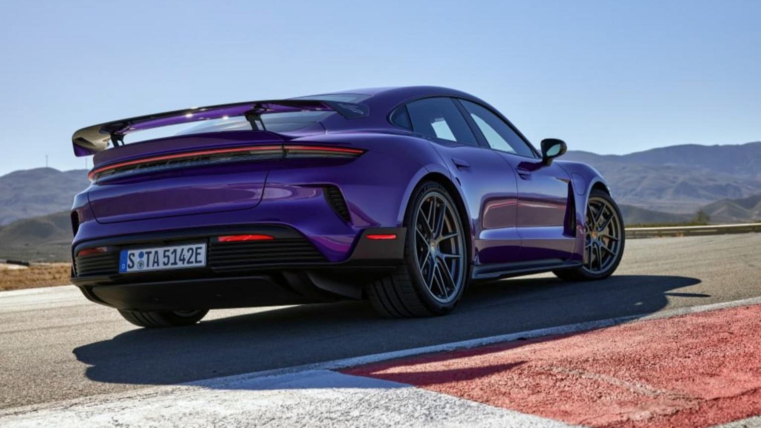 a purple sports car on a road