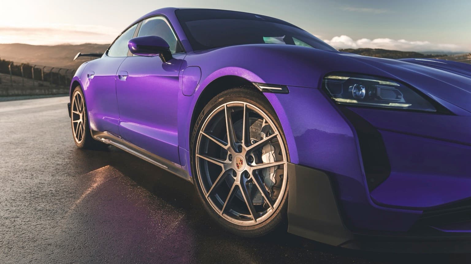 a purple sports car parked on a road