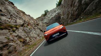 une voiture rouge roulant sur une route