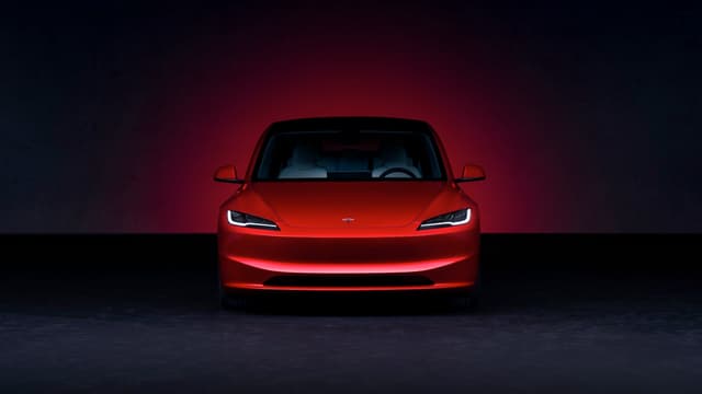 a red car in a dark room