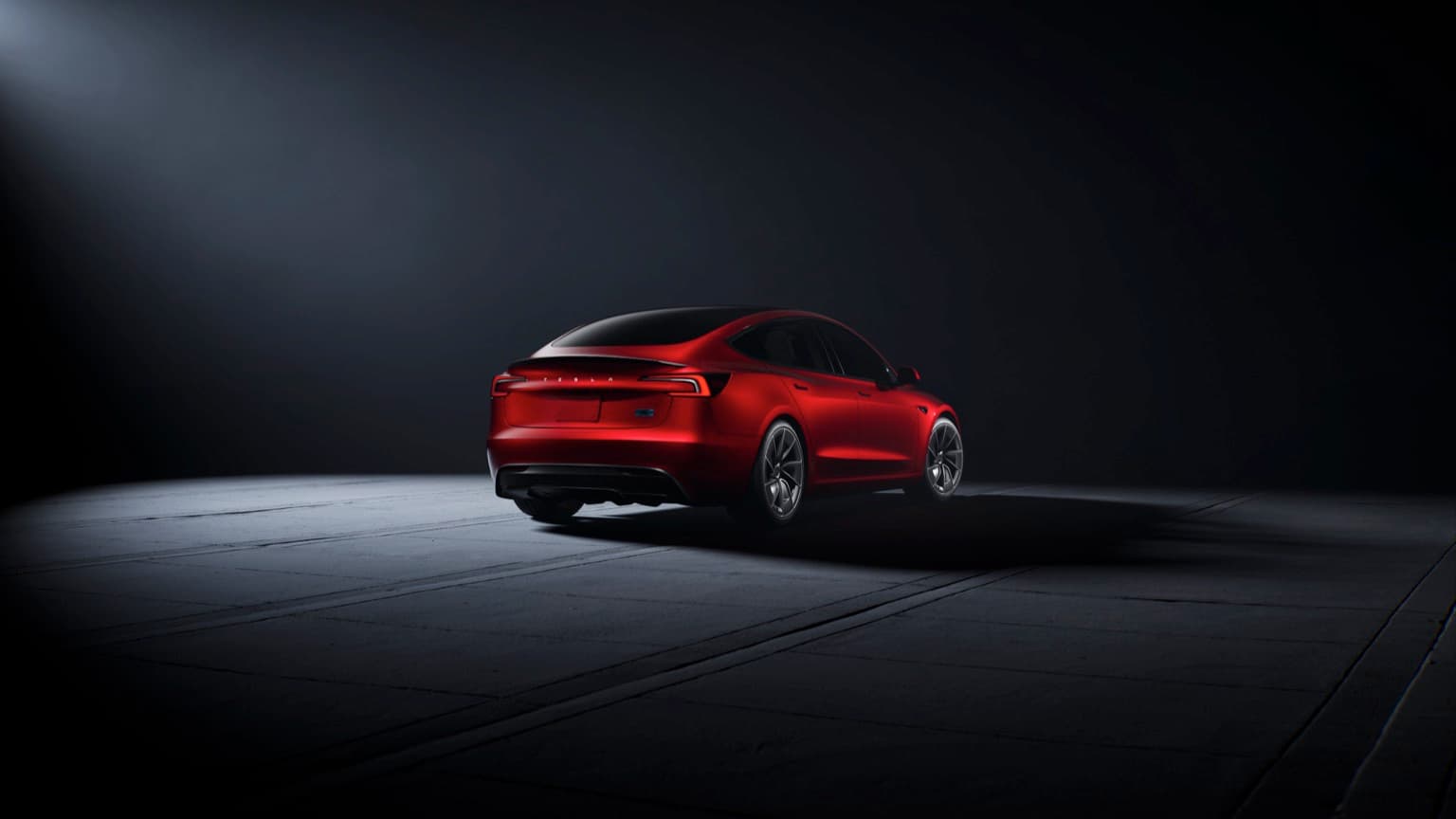 a red car parked in a dark room