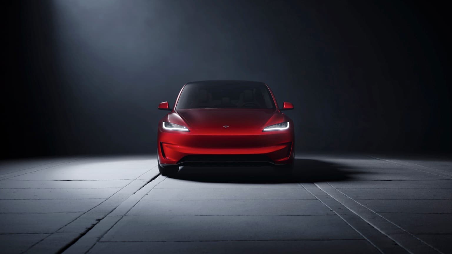 a red car parked on a concrete surface