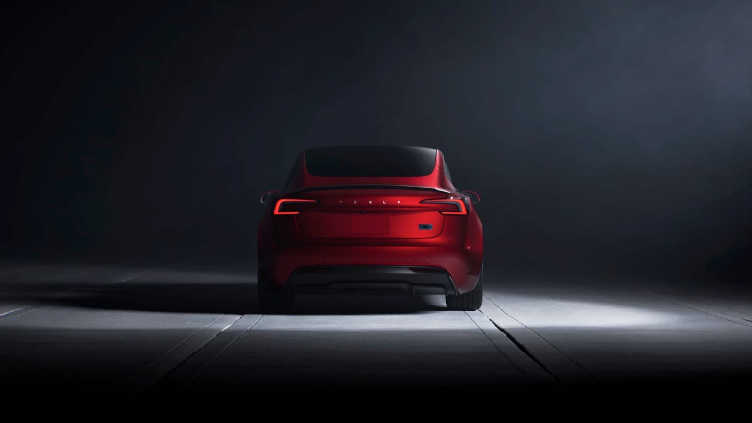 a red car parked in a dark room