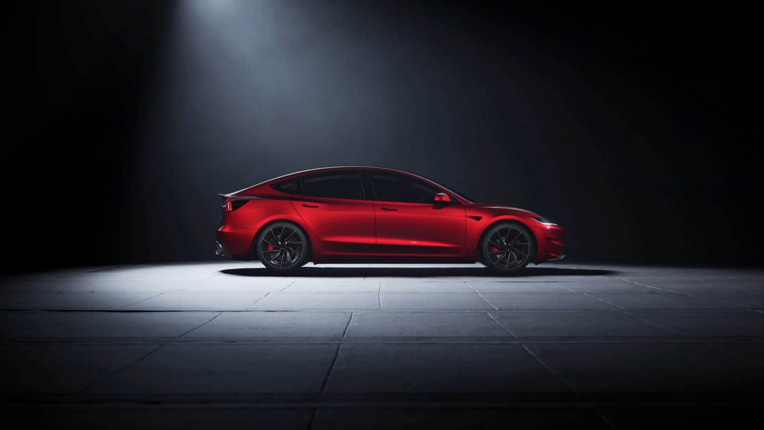 a red car parked on a concrete surface