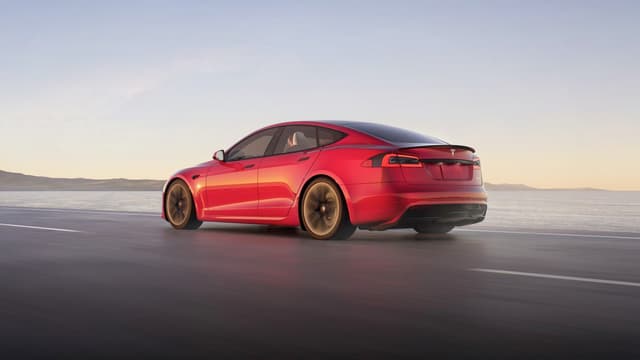 a red car driving on a road