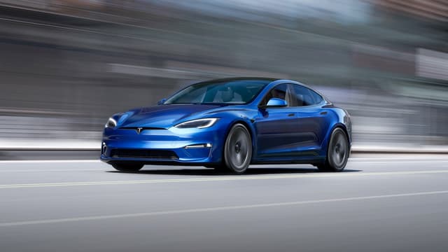 a blue car on a road