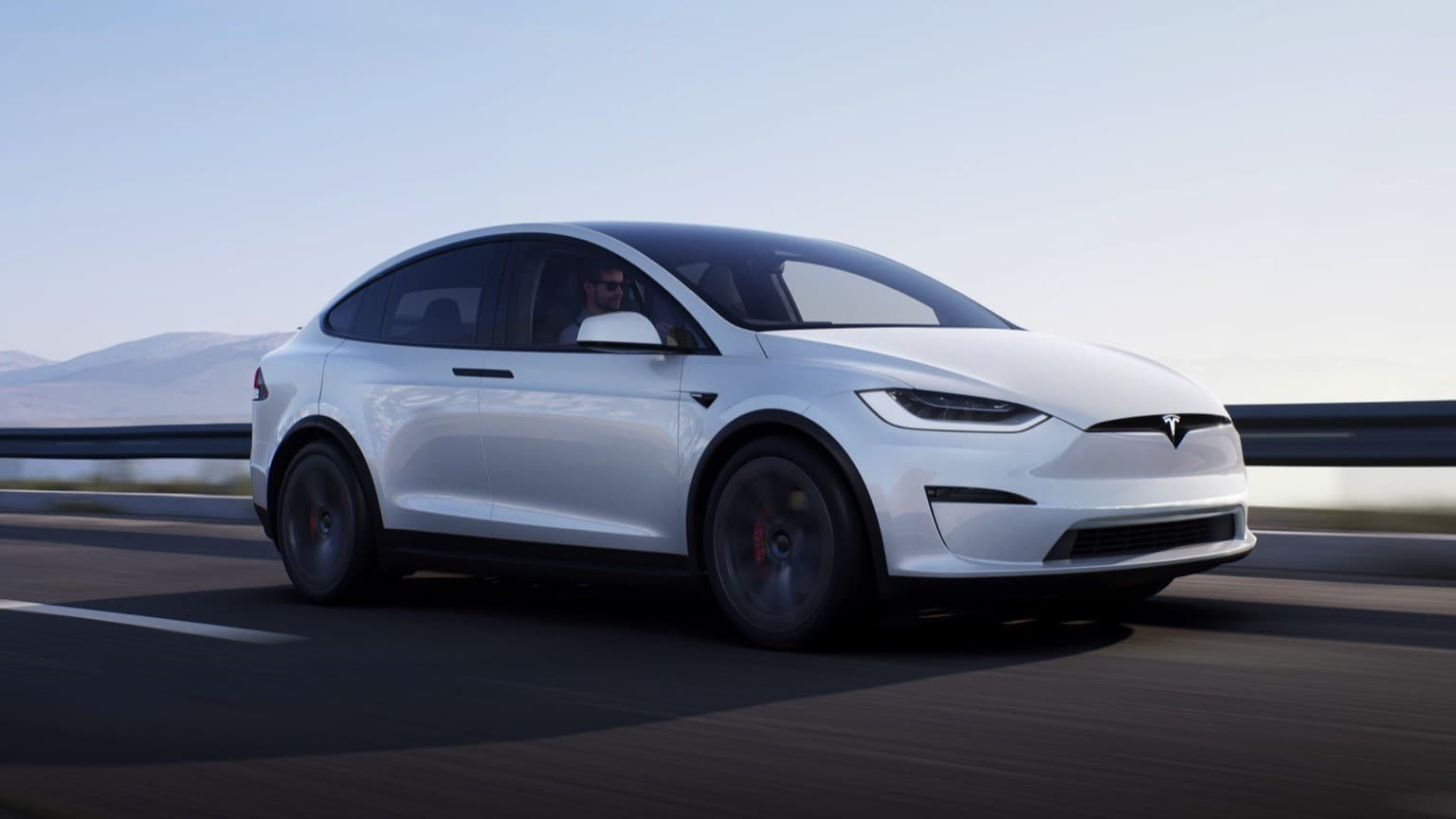 a white car driving on a road