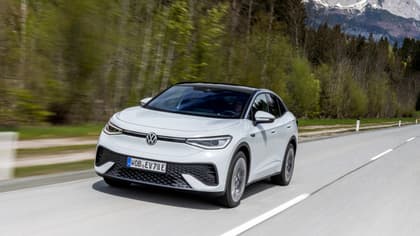 a white car driving on a road