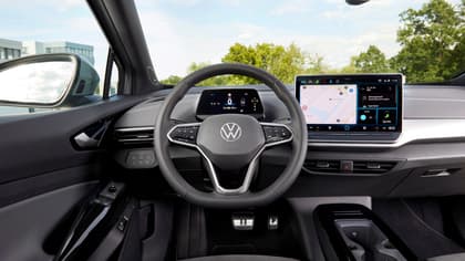 the interior of a car with a steering wheel and a screen