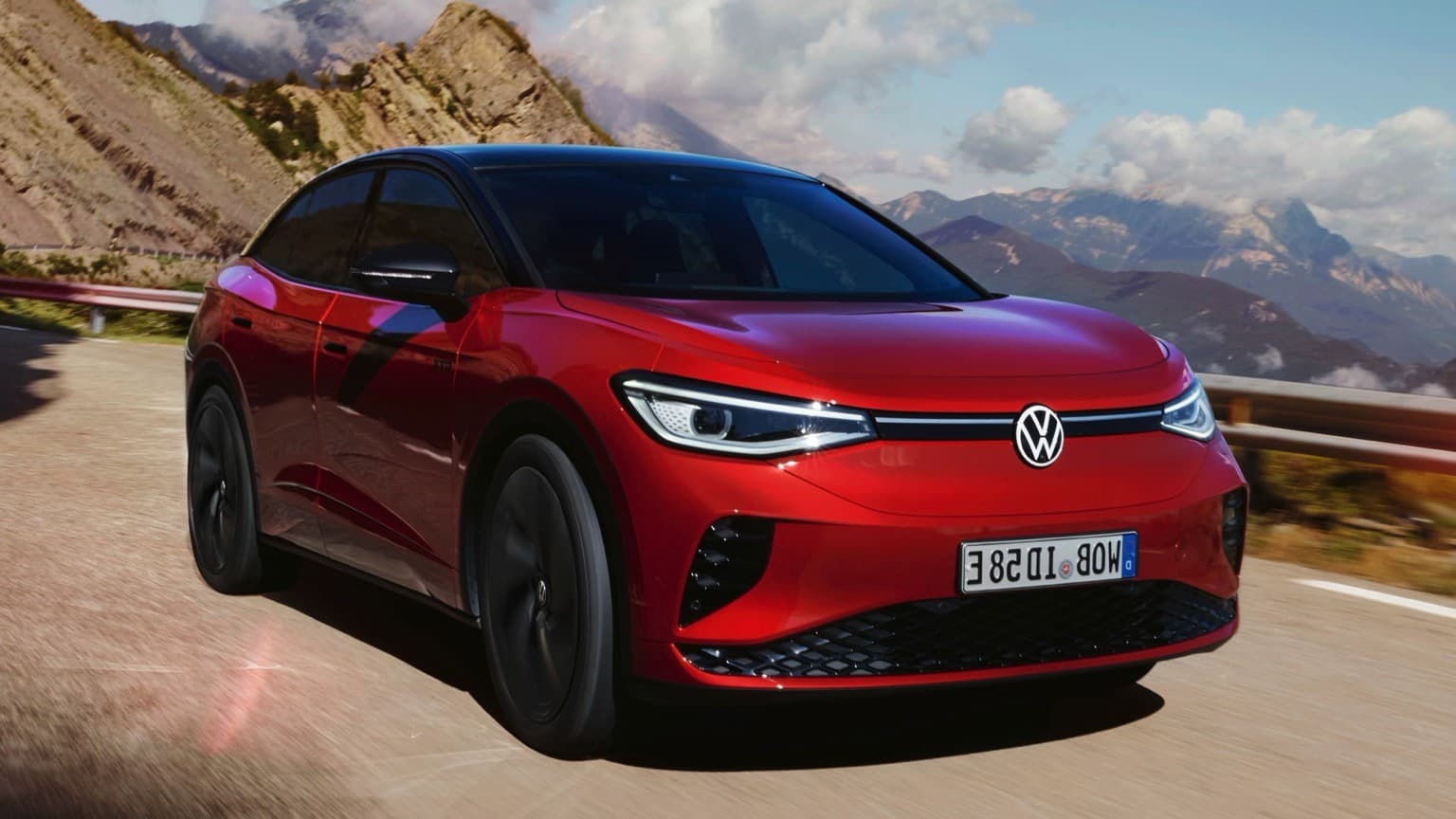 a red car driving on a road