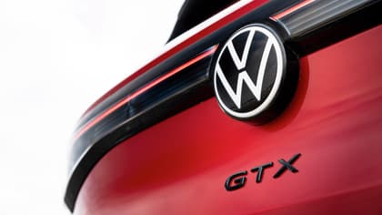 a close up of a logo on a red car