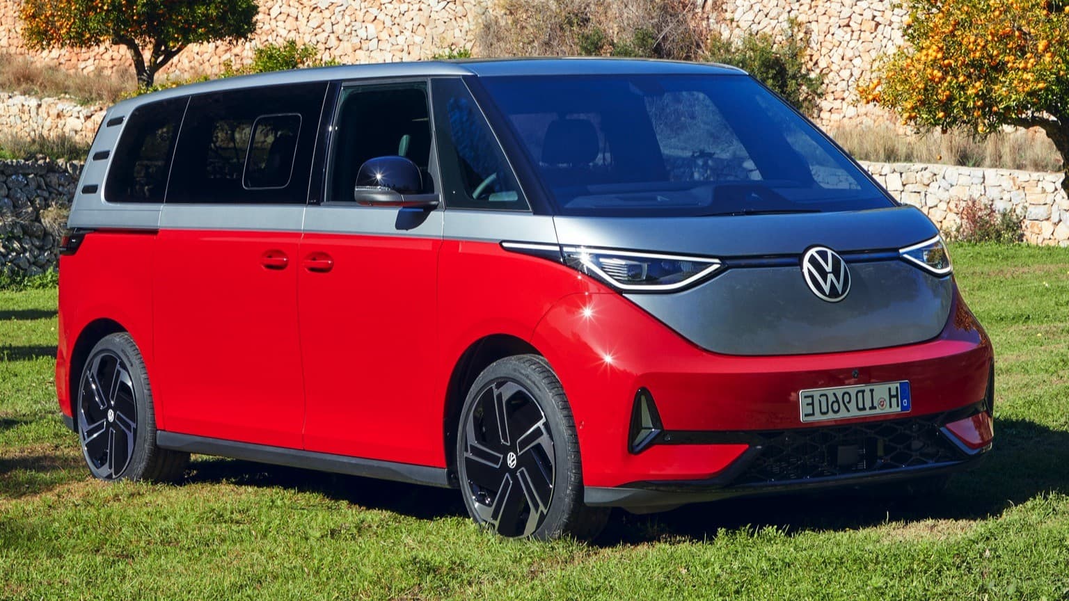 a red and grey van parked on grass