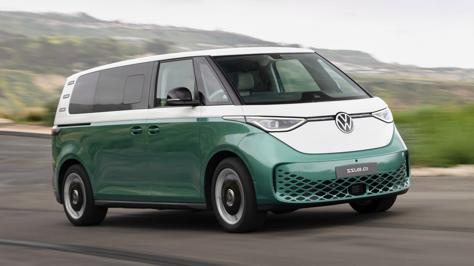 a green and white van on a road