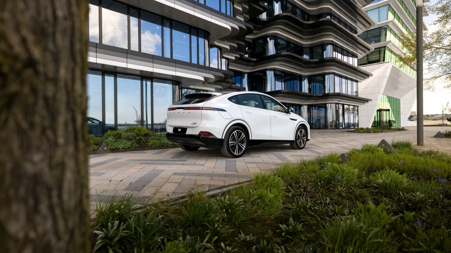 a white car parked in front of a building