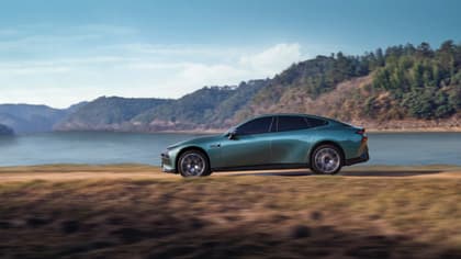 une voiture roulant sur une route près d'un plan d'eau