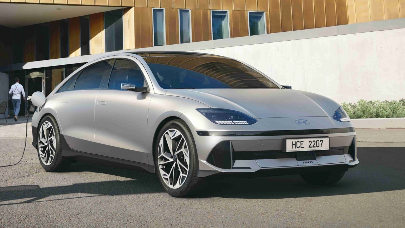 a silver car parked in front of a building