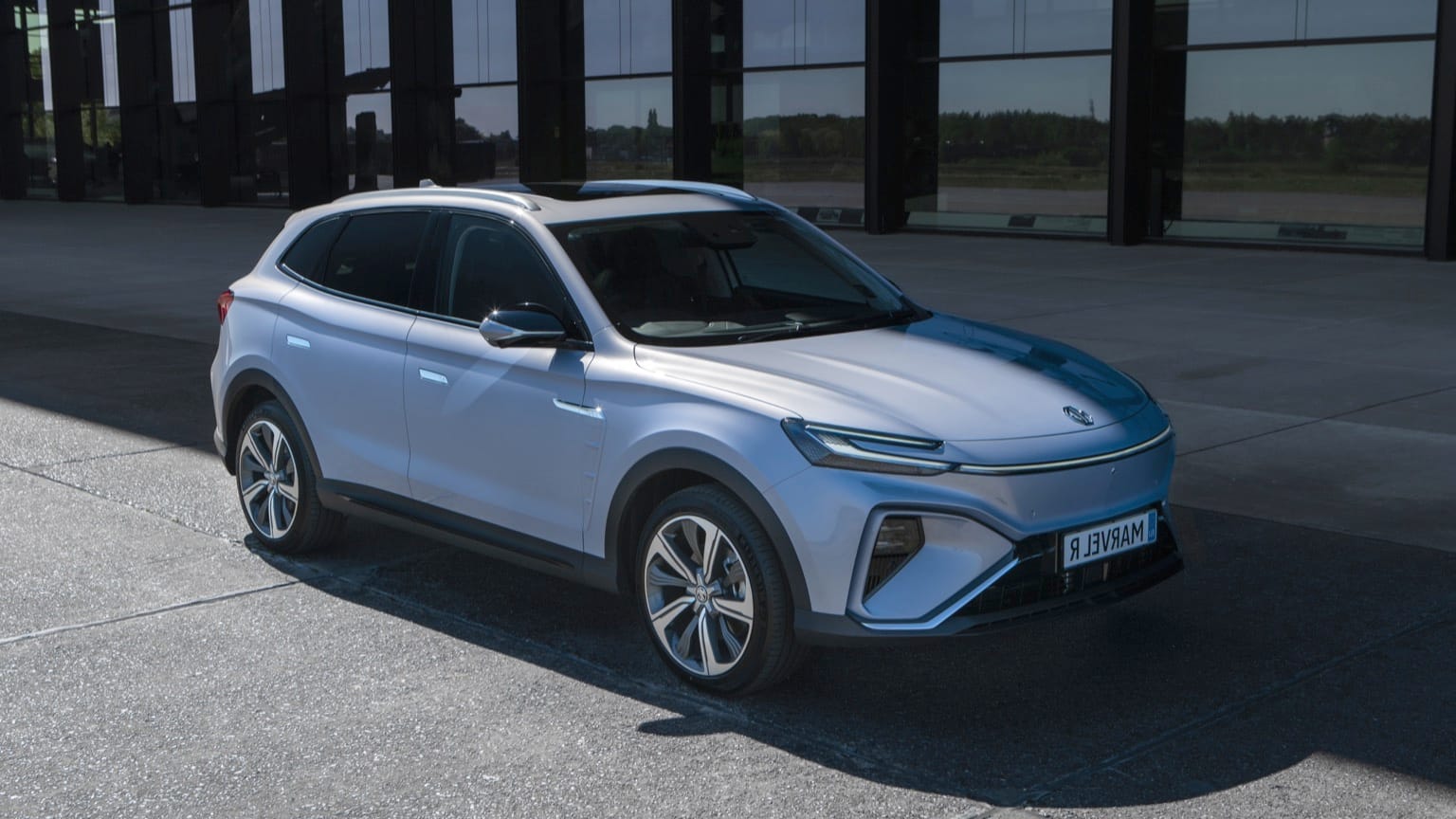 a silver suv parked in front of a building