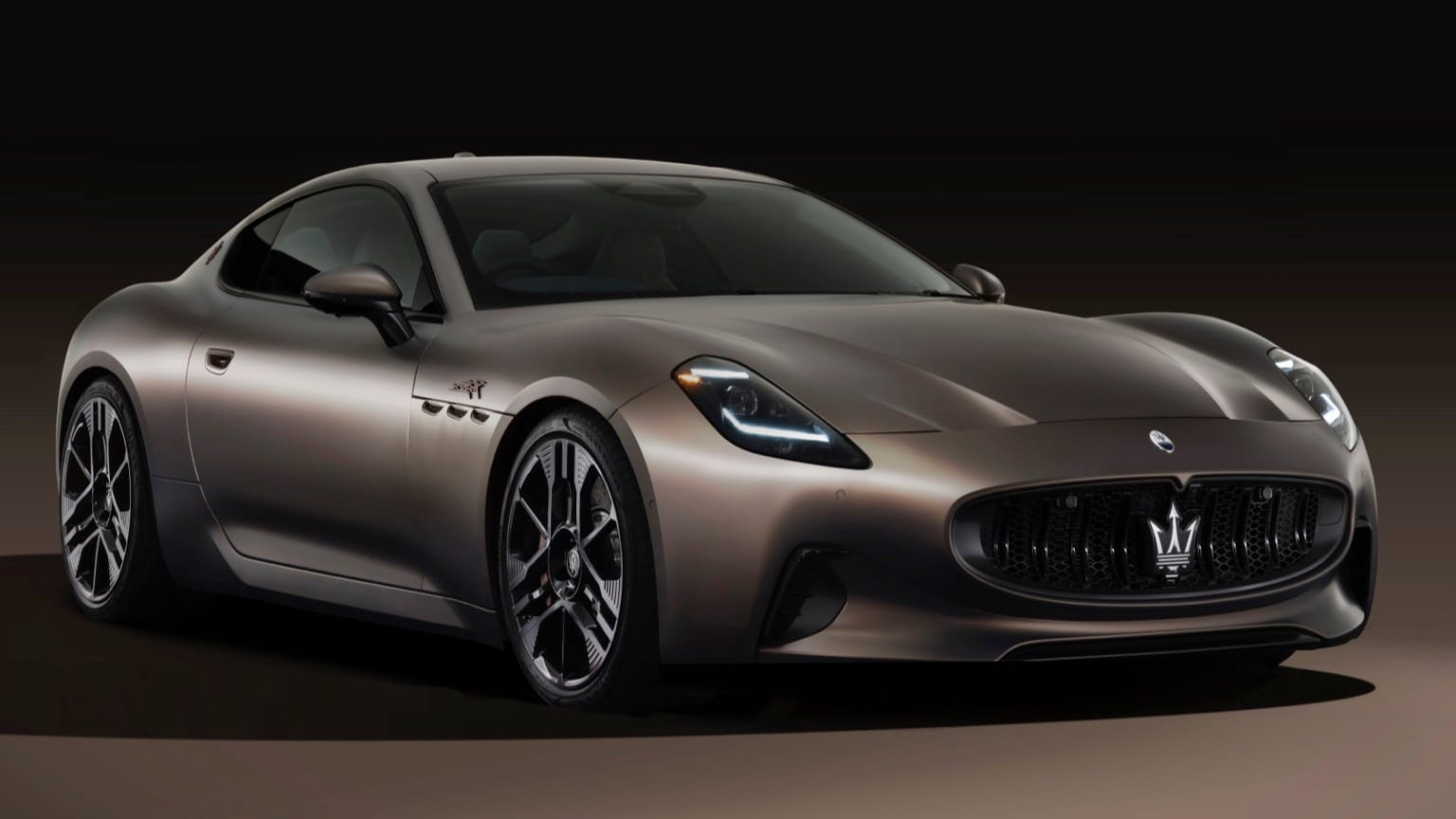 a black sports car with a black background