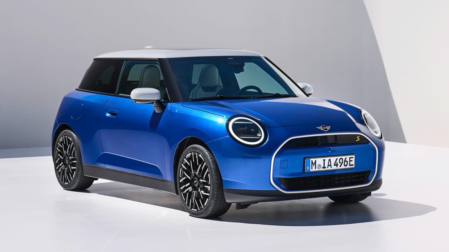 a blue car parked on a white surface