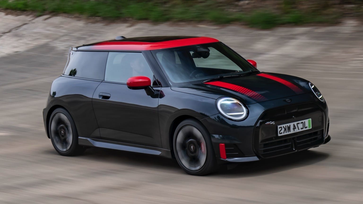a black and red car on a road