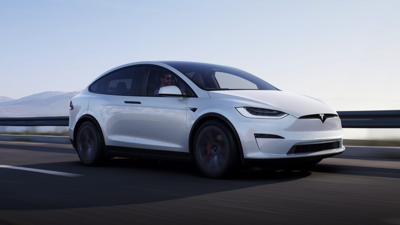 a white car driving on a road