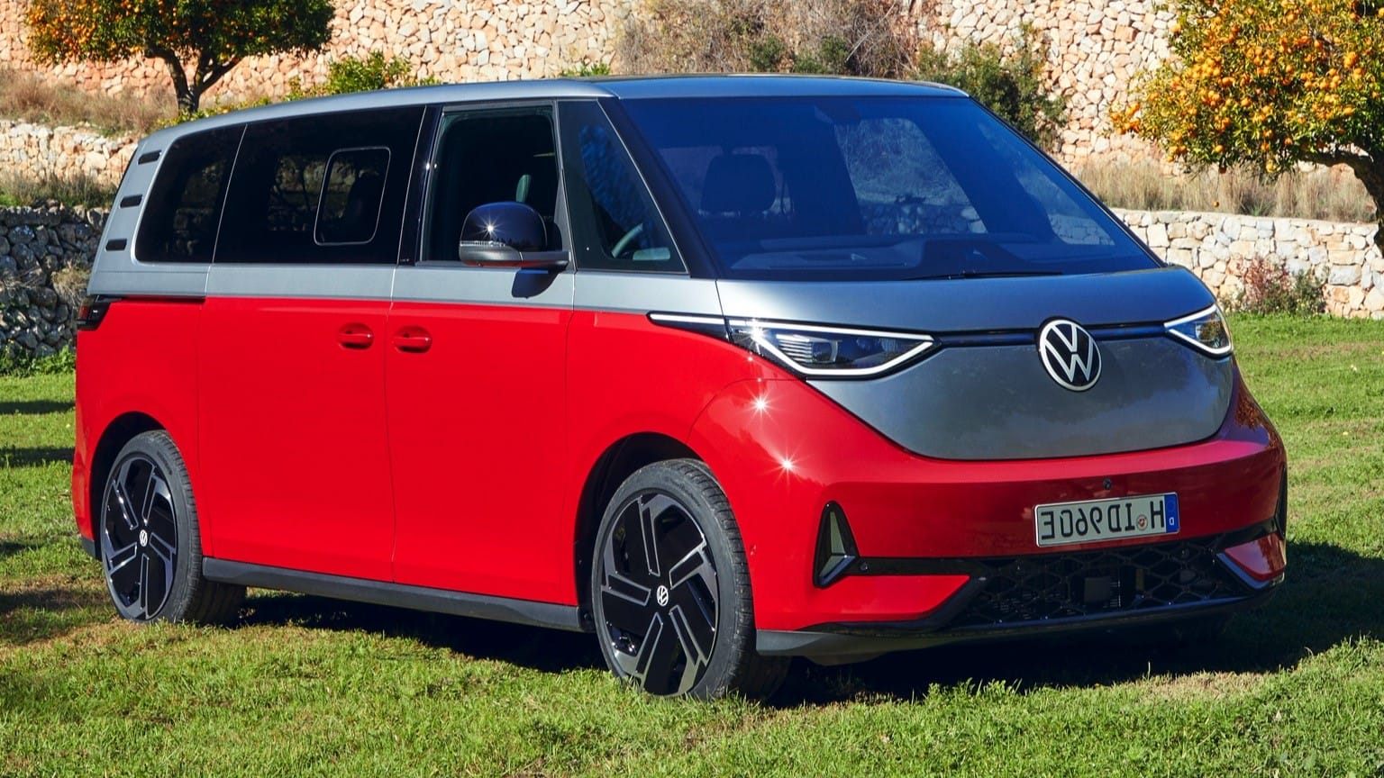 a red and grey van parked on grass