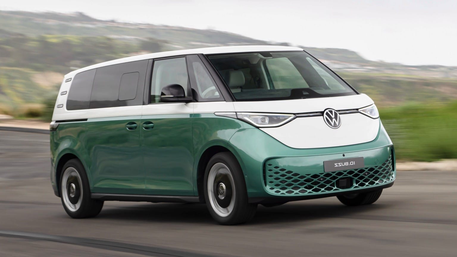 a green and white van on a road