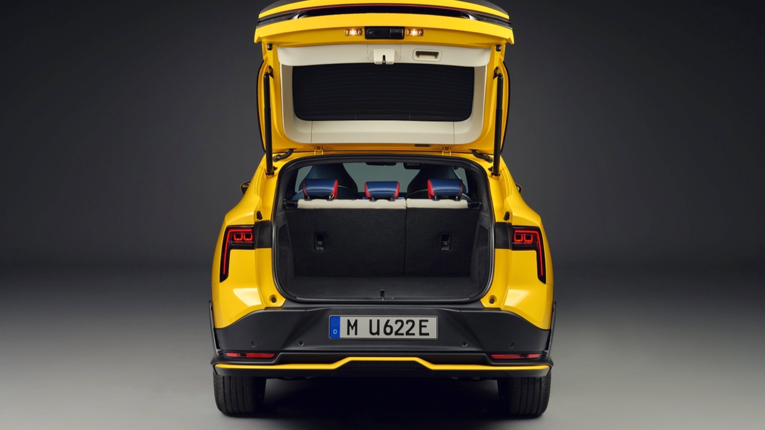 the back of a yellow car with the trunk open