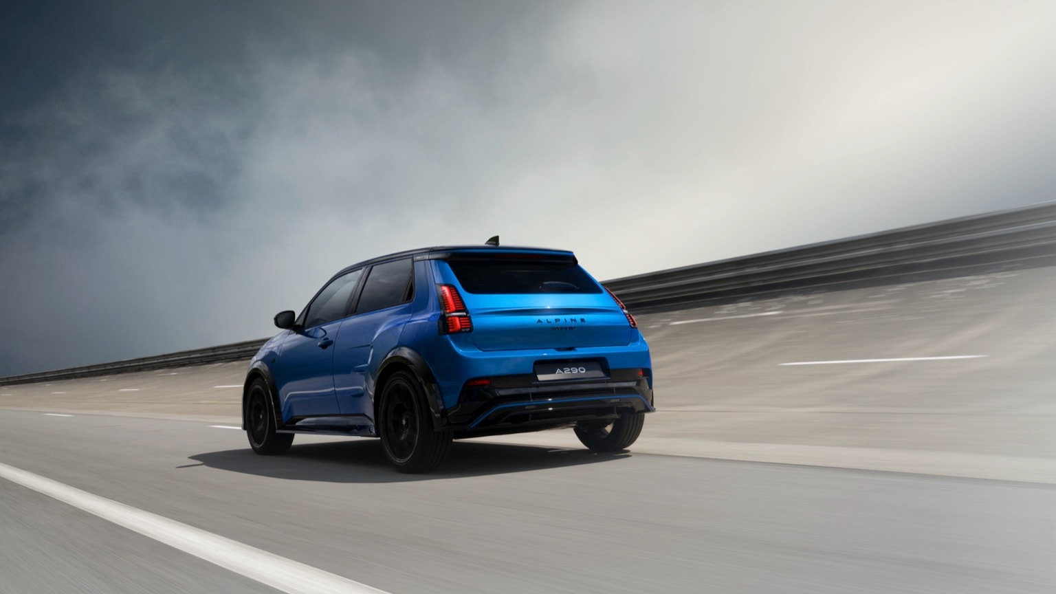 a blue car driving on a road