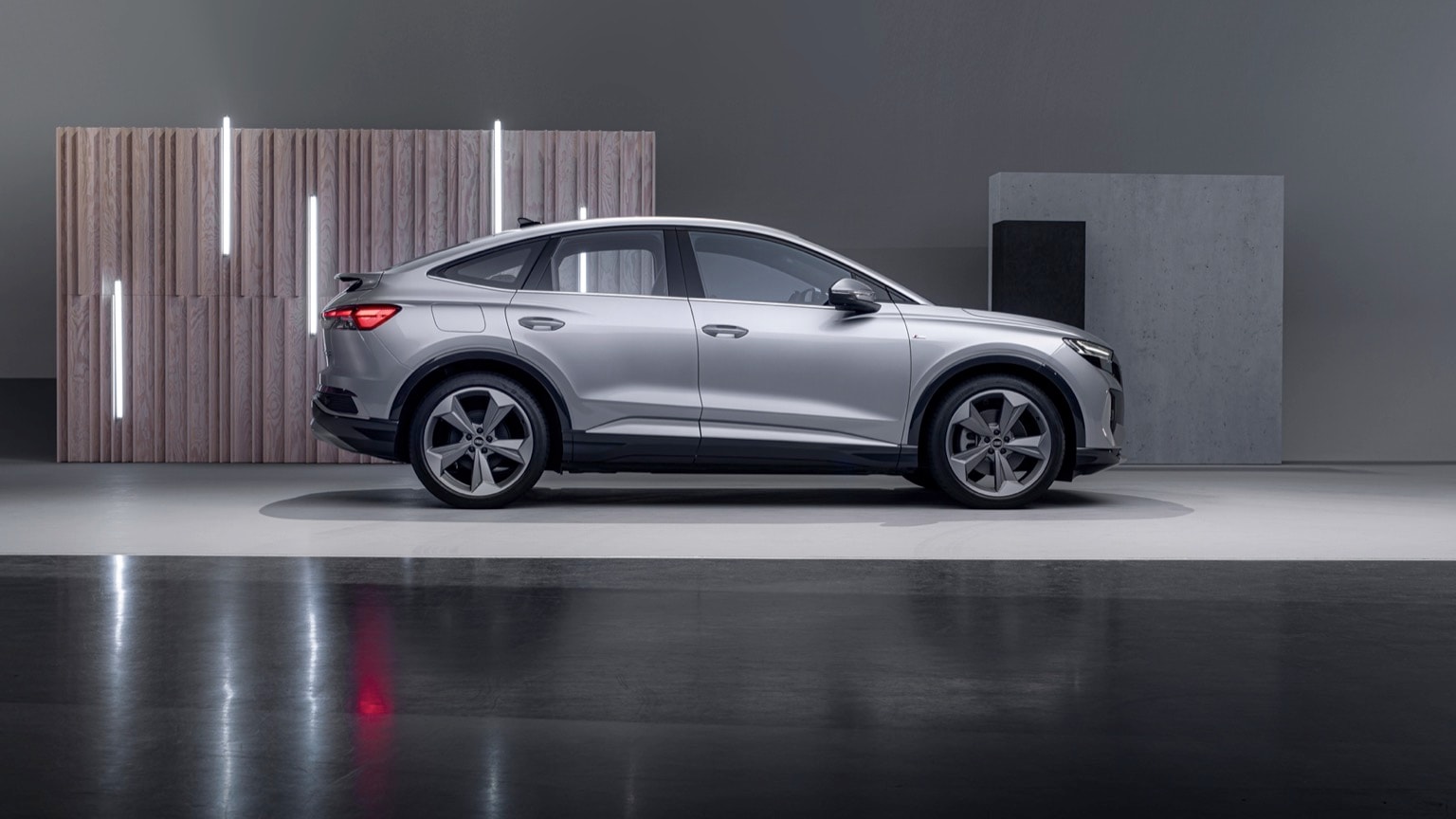a silver car parked in a showroom