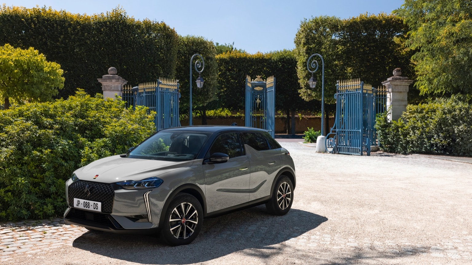 a car parked in front of a gated entrance