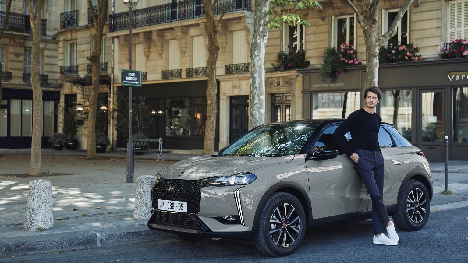 a man leaning on a car