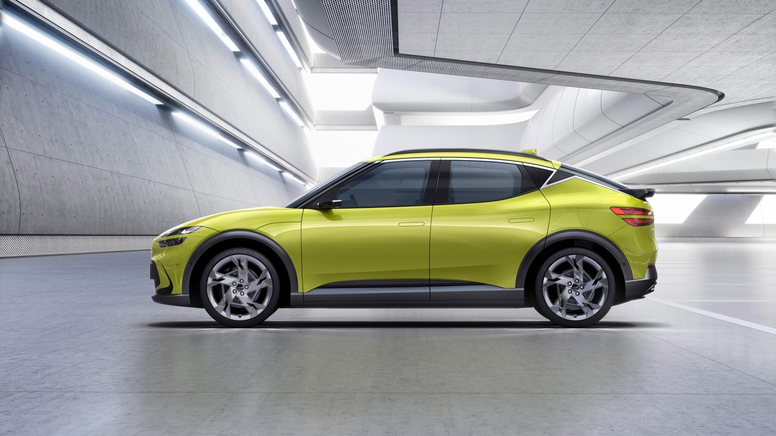 a green car parked inside a building