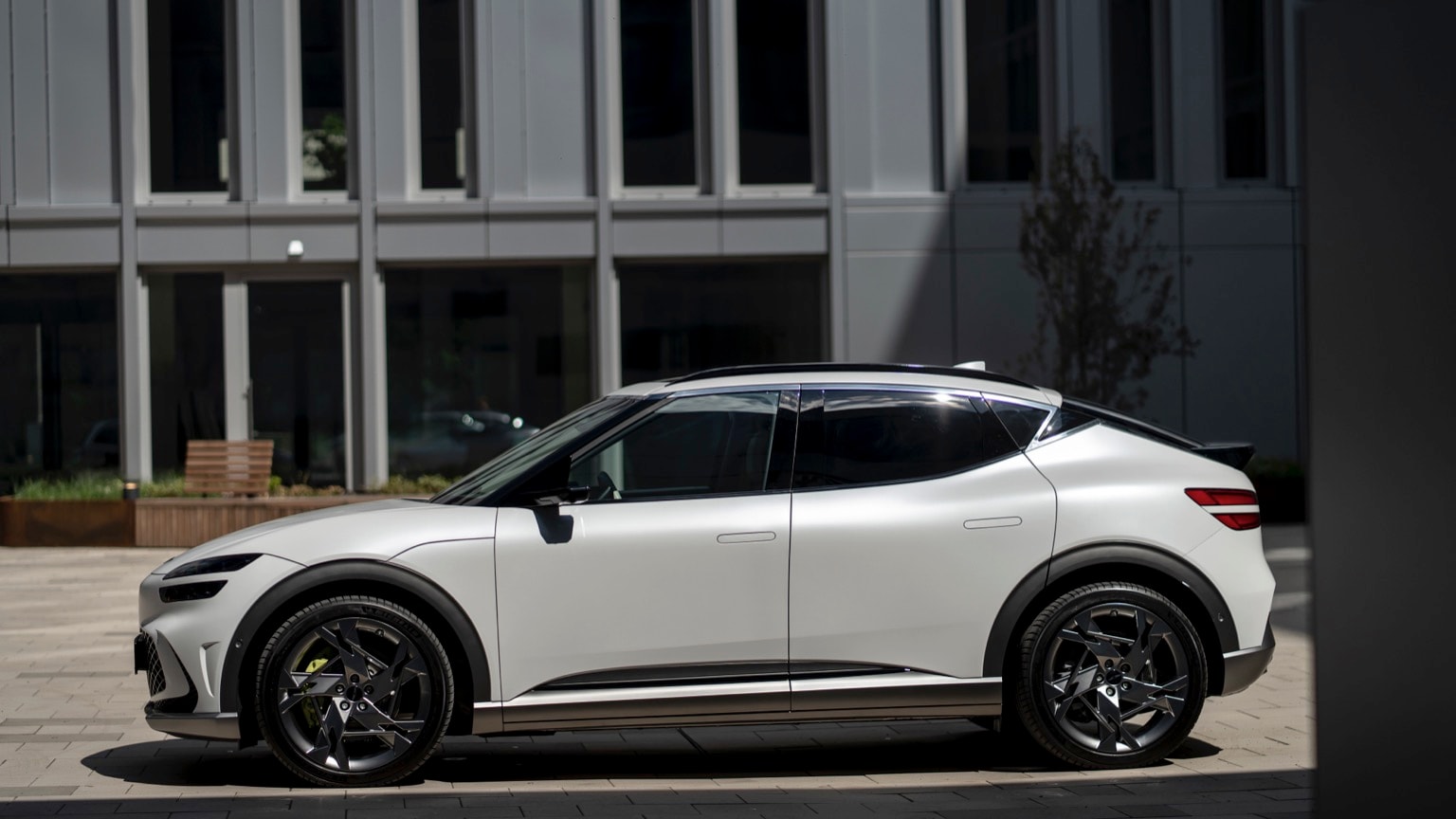 a white car parked on a brick surface