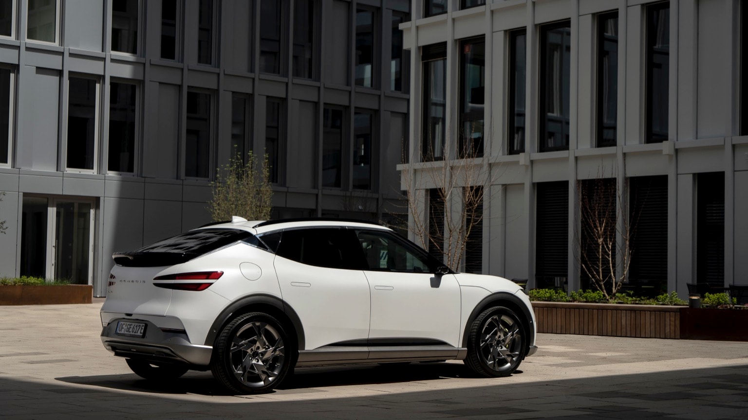 a white car parked in front of a building