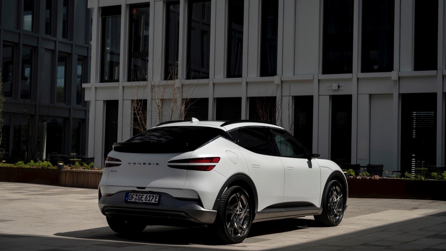 a white car parked in front of a building