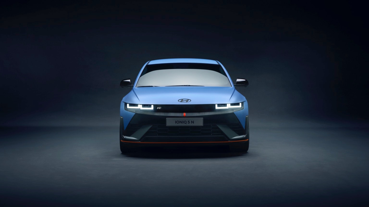 a blue car with its headlights turned on