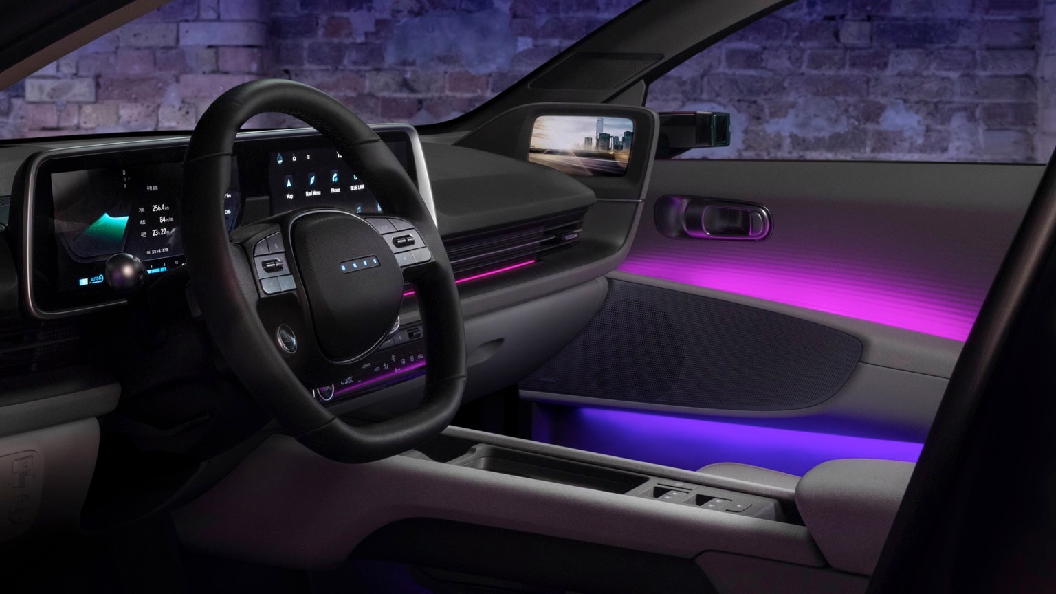 the interior of a car with a steering wheel and purple and pink lights