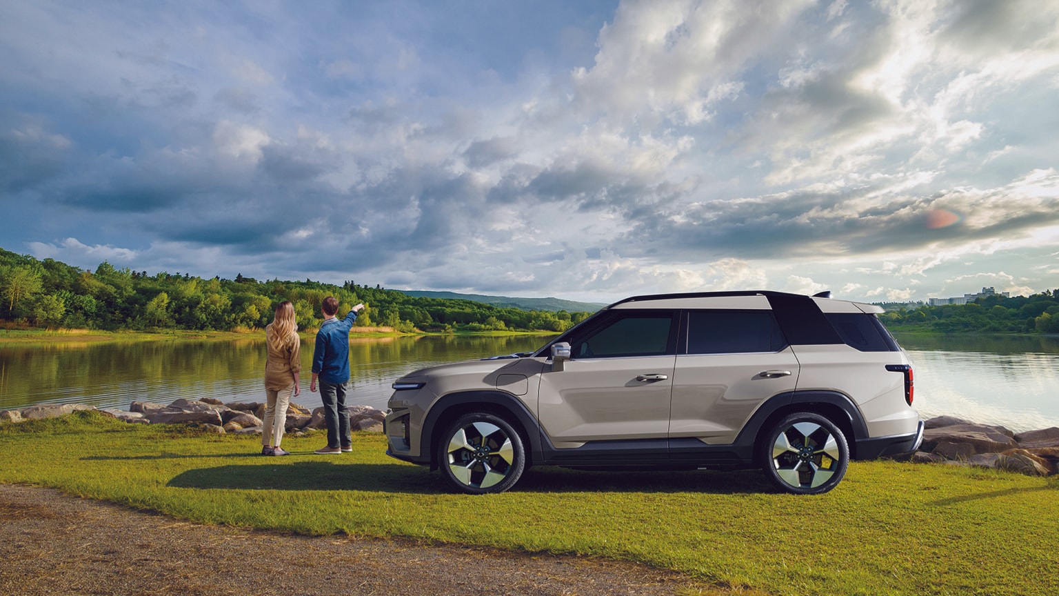 a couple of people standing next to a car