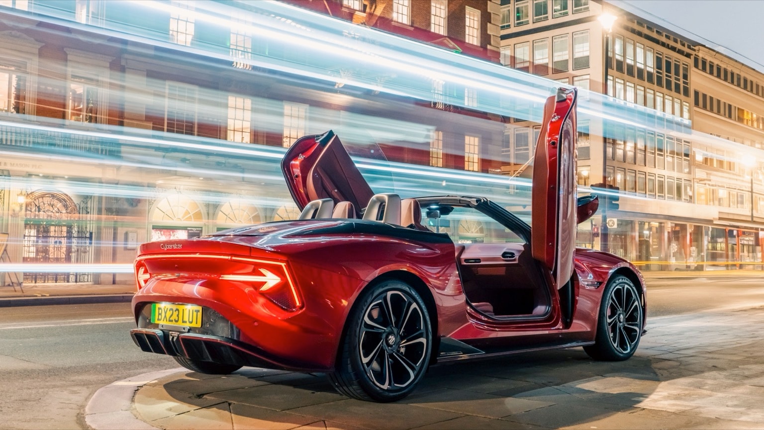 a red convertible car with its doors open