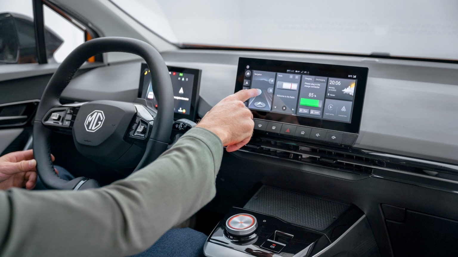 a person's hand touching a touch screen in a car