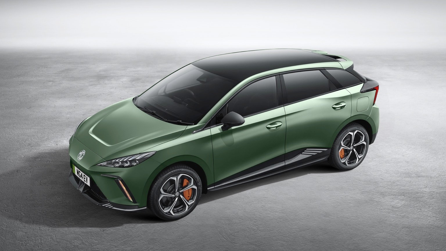 a green car parked on a concrete surface