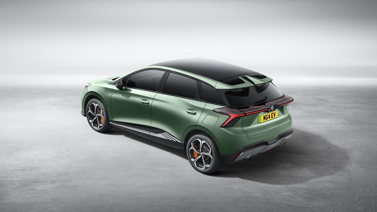 a green car parked on a concrete surface